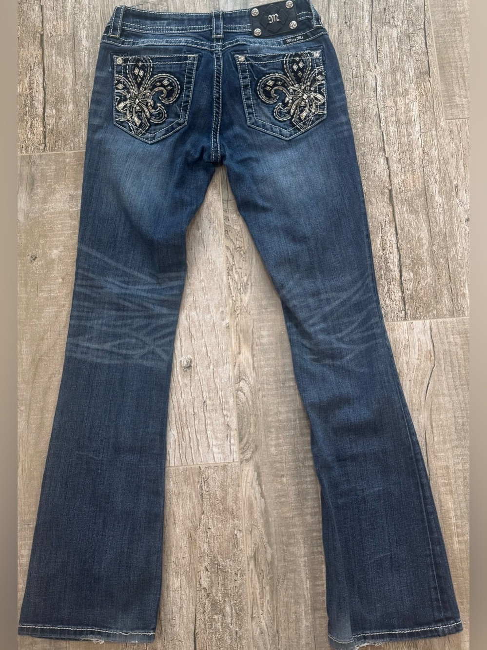 Miss Me Signature-Rise Boot Cut Jeans with Embroidered Fleur‑de‑Lis Pockets